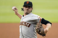 FILE -San Francisco Giants stating pitcher Kevin Gausman works against the Atlanta Braves during the first inning of a baseball game Friday, Aug. 27, 2021, in Atlanta. The Toronto Blue Jays have reached an agreement with right-hander Kevin Gausman on a five-year, $110 million contract, pending a physical, a person familiar with the deal told The Associated Press late Sunday, Nov. 28, 2021. (AP Photo/John Bazemore, File)