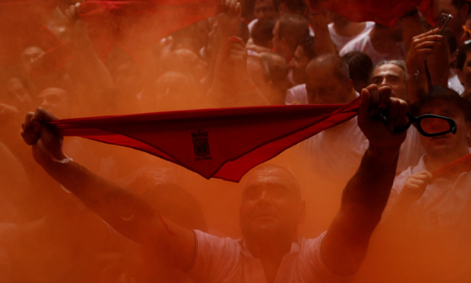 <p>A reveller holds up the traditional red scarf during the firing of ‘chupinazo’ which opens the San Fermin festival in Pamplona, Spain, July 6, 2018. (Photo: Susana Vera/Reuters) </p>