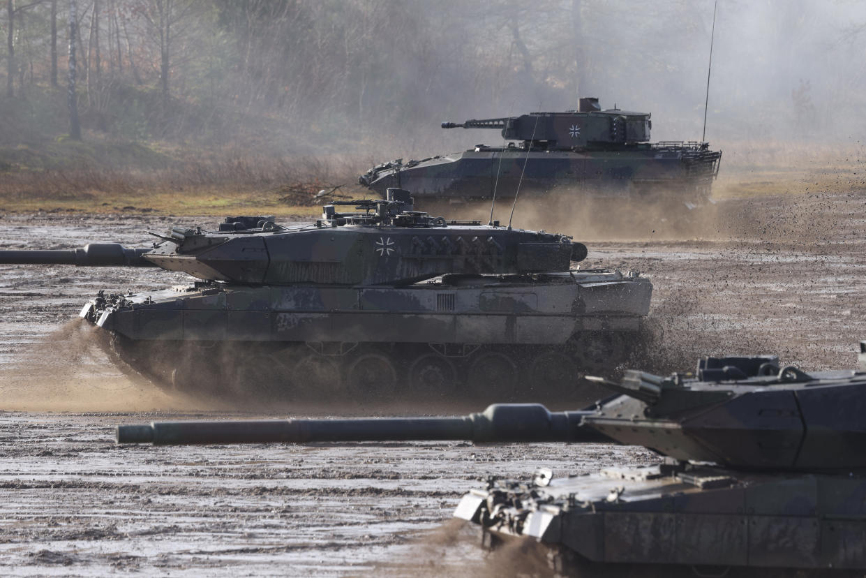 Two Leopard 2 A6 heavy battle tanks and a Puma infantry fighting vehicle of the Bundeswehr's 9th Panzer Training Brigade 
