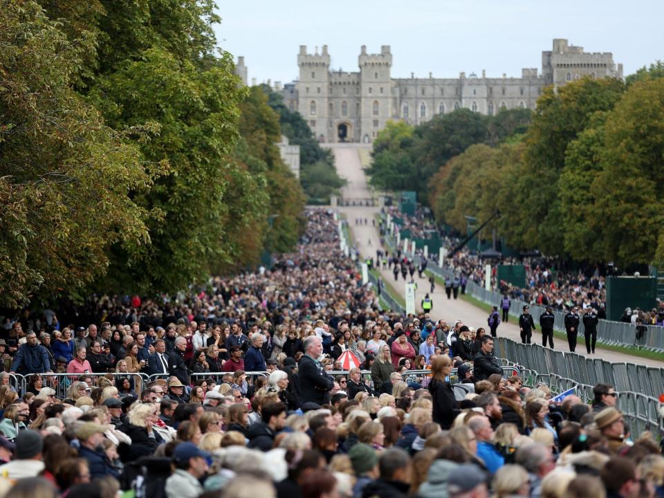 People gather on the long walk outside of Windsor Castle during Queen Elizabeth's funeral.