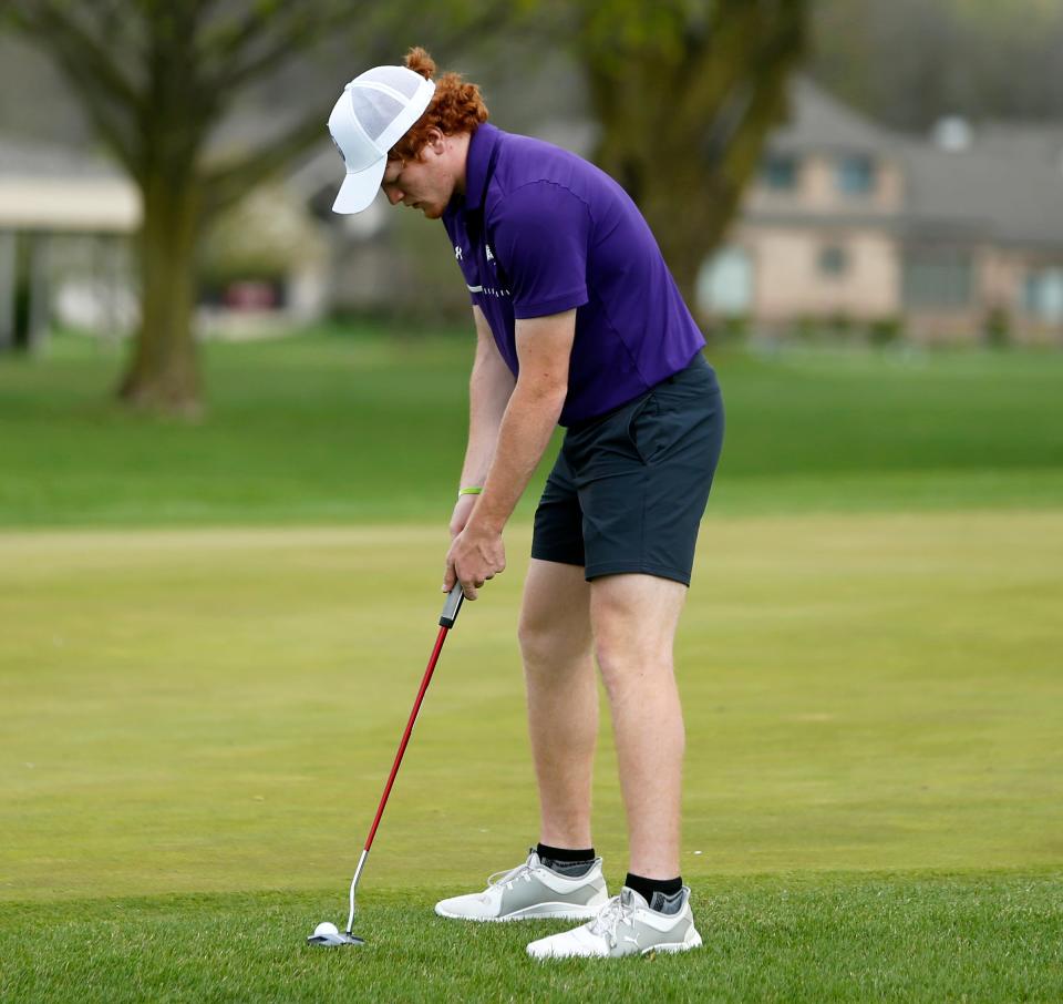 Elkhart Christian Academy senior Aiden Hibbard putts on the first hole during a match with Trinity at Greenlawn Tuesday, April 16, 2024, at Bent Oak GC in Elkhart.