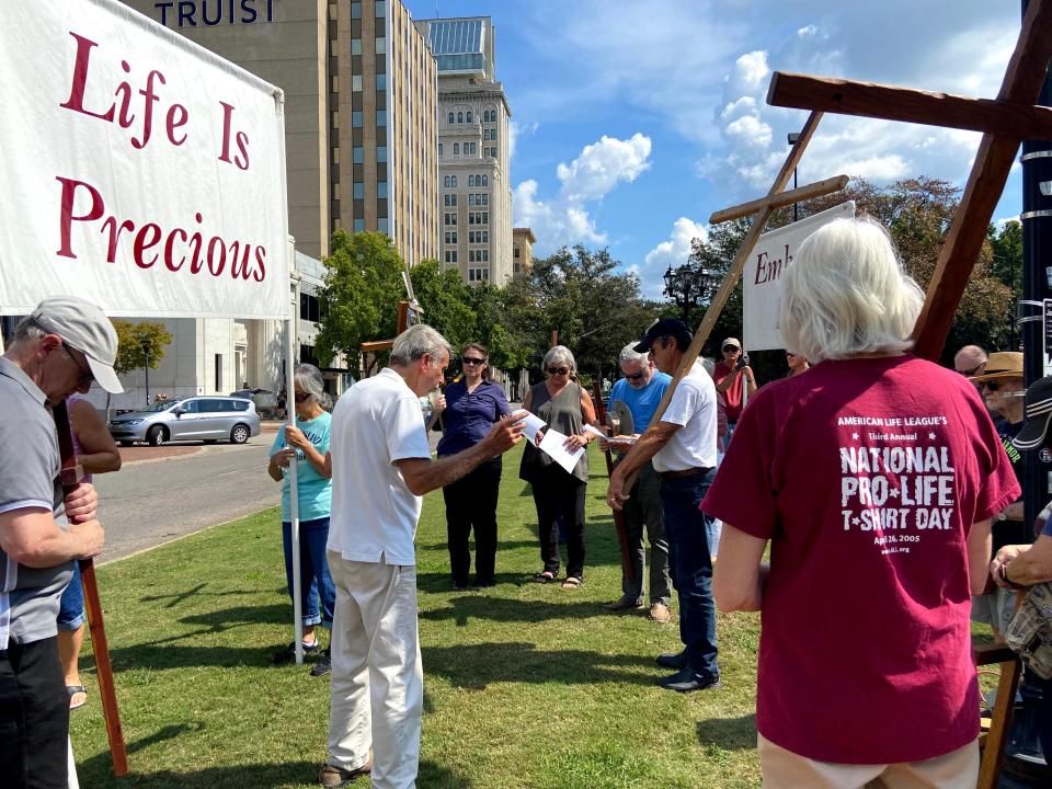 Gary Garner leads a prayer for a group protesting abortion in October 2021 across the street from the Augusta Common.