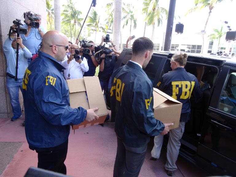 FBI agents remove documents from the headquarters of the CONCACAF soccer organization after a raid on May 27, 2015 in Miami Beach, Florida