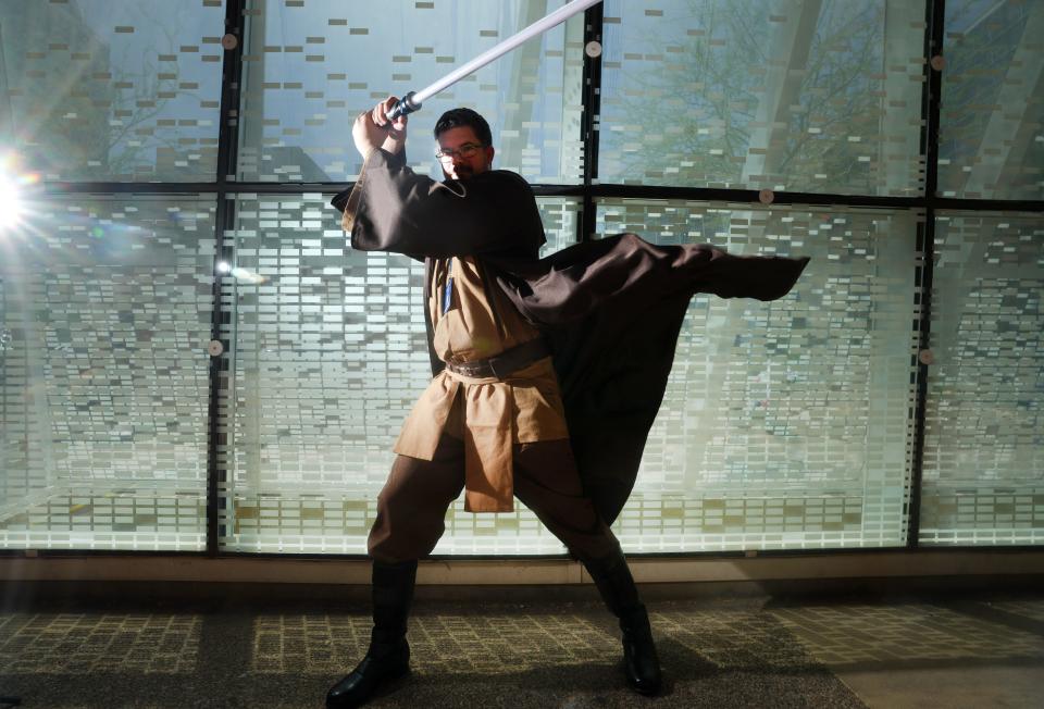 Vincent DeMartini, dressed as Qui-Gon Jinn, poses for a photo during Fan Fusion at the Phoenix Convention Center on June 3, 2023, in Phoenix.