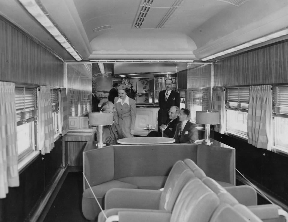 Baltimore & Ohio Railroad stewardess Rosemary Madden welcomes Akron guests to an observation lounge with a cocktail bar aboard the New Columbian Strata-Dome train on exhibit May 11, 1949, at the Howard Street station.