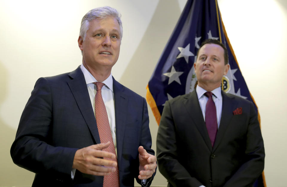 Robert C. O'Brien, left, United States National Security Advisor, and Richard Grenell, right, United States Ambassador to Germany, address the media during a press conference in Berlin, Germany, Monday, Jan. 20, 2020 prior to the signing of an agreement between Kosovo and Serbia, establishing air service between the two capitals. (AP Photo/Michael Sohn)