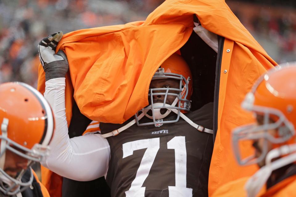 Browns defensive end Ahtyba Rubin pulls on his coat on the sidelines in the third quarter against the Steelers, Sunday, Nov. 24, 2013, in Cleveland.