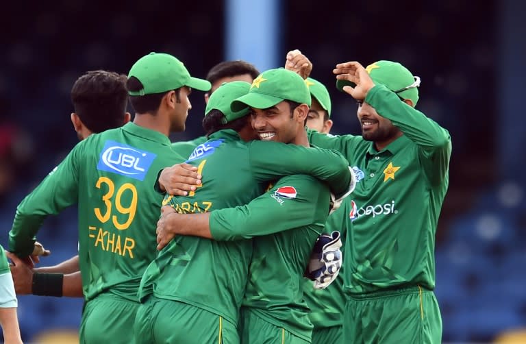 Pakistan's Shadab Khan (R) embraces team Pakistan's captain/wicketkeeper Sarfraz Ahmed as they celebrate their victory at the end of the second of four-T20I-match between West Indies and Pakistan March 30, 2017
