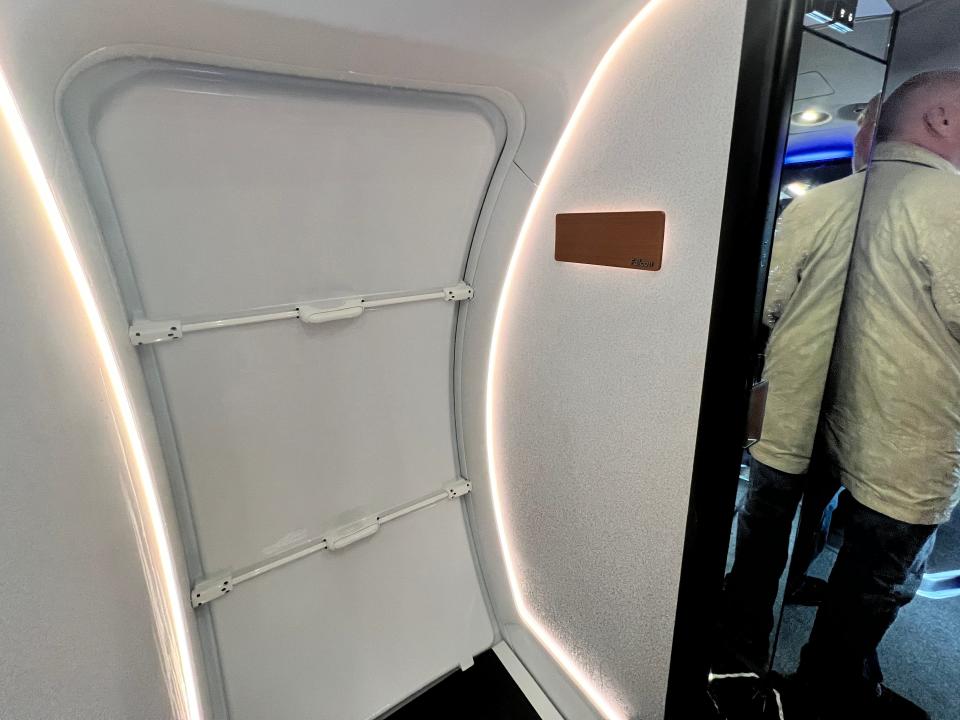 The door of a Falcon 10X with a wood sign reading "Falcon", plus a small mirror.