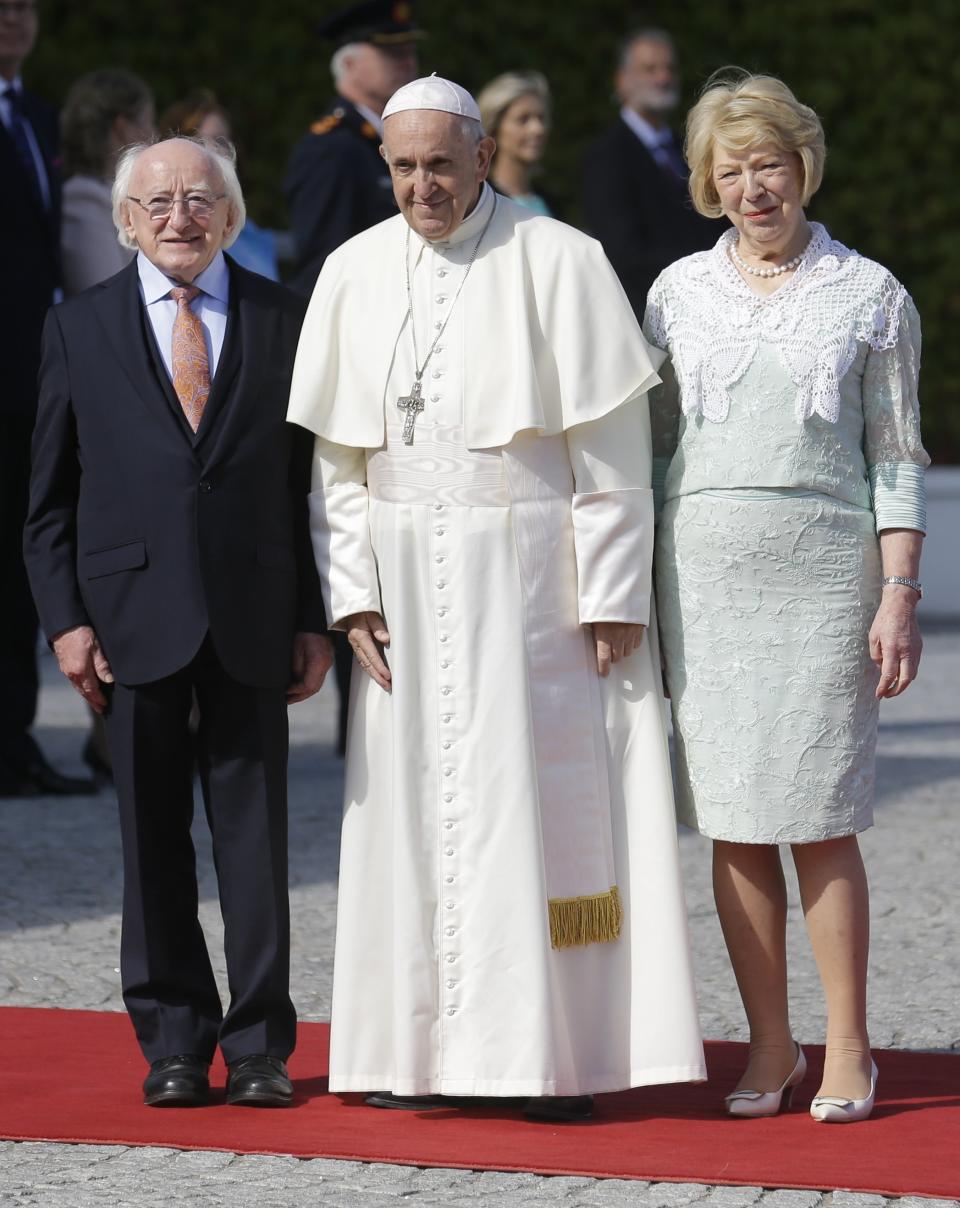 Pope Francis, center, is flanked by Irish President Michael D. Higgins, left, and President's wife Sabina at the Presidential residence in Dublin, Ireland, Saturday, Aug. 25, 2018. Pope Francis is on a two-day visit to Ireland. (AP Photo/Peter Morrison)