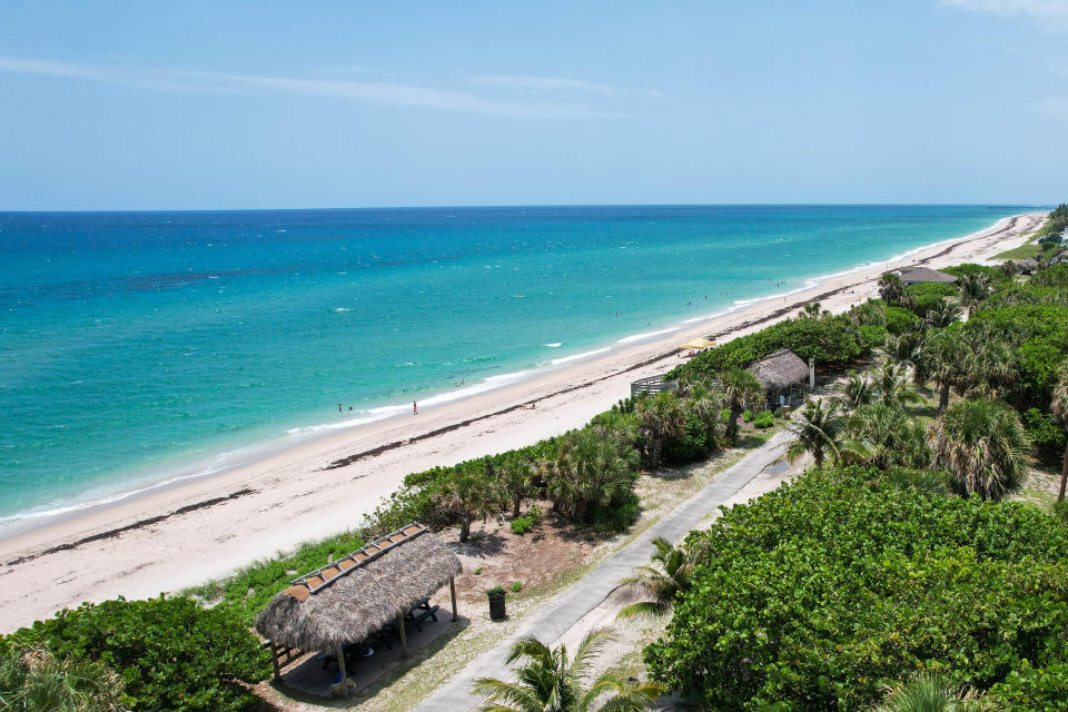 Beachgoers relax on the sand in Phipps Ocean Park. The Preservation Foundation of Palm Beach is spearheading plans and raising money to redevelop the park.