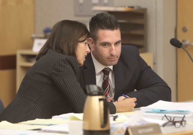 Ex-deputy sheriff Richard Fischer listens as his attorney Gretchen von Helms speaks to him on the day of his sentencing hearing in Vista Superior Court.