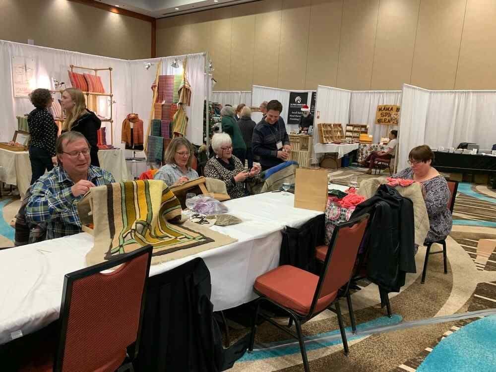 Organizers of P.E.I.'s longest-running juried craft fair have been noticing a surge of interest in handmade goods. Pictured is a rughooking demonstration at last year's P.E.I. Crafts Council Christmas fair.   (P.E.I. Crafts Council - image credit)