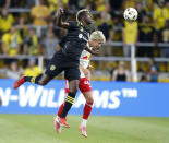 Columbus Crew forward Gyasi Zardes, left, heads the ball over New York Red Bulls defender John Tolkin during the first half of an MLS soccer match in Columbus, Ohio, Tuesday, Sept. 14, 2021. (AP Photo/Paul Vernon)