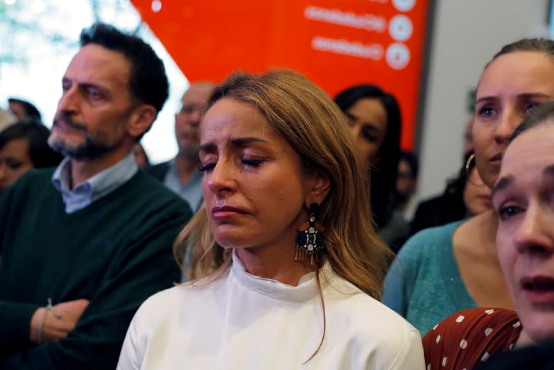 Aides react as Ciudadanos leader Rivera announces his resignation at their headquarters the day after general elections, in Madrid
