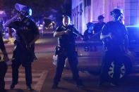 Police stand at an intersection after an officer was shot, Wednesday, Sept. 23, 2020, in Louisville, Ky. A grand jury has indicted one officer on criminal charges six months after Breonna Taylor was fatally shot by police in Kentucky. The jury presented its decision against fired officer Brett Hankison Wednesday to a judge in Louisville, where the shooting took place. (AP Photo/John Minchillo)