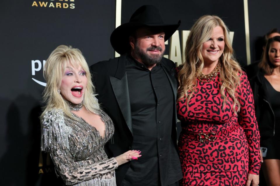 Dolly Parton and Brooks, co-hosts of the Academy of Country Music Awards in May last year, pose with his wife, Yearwood, at the event. WireImage