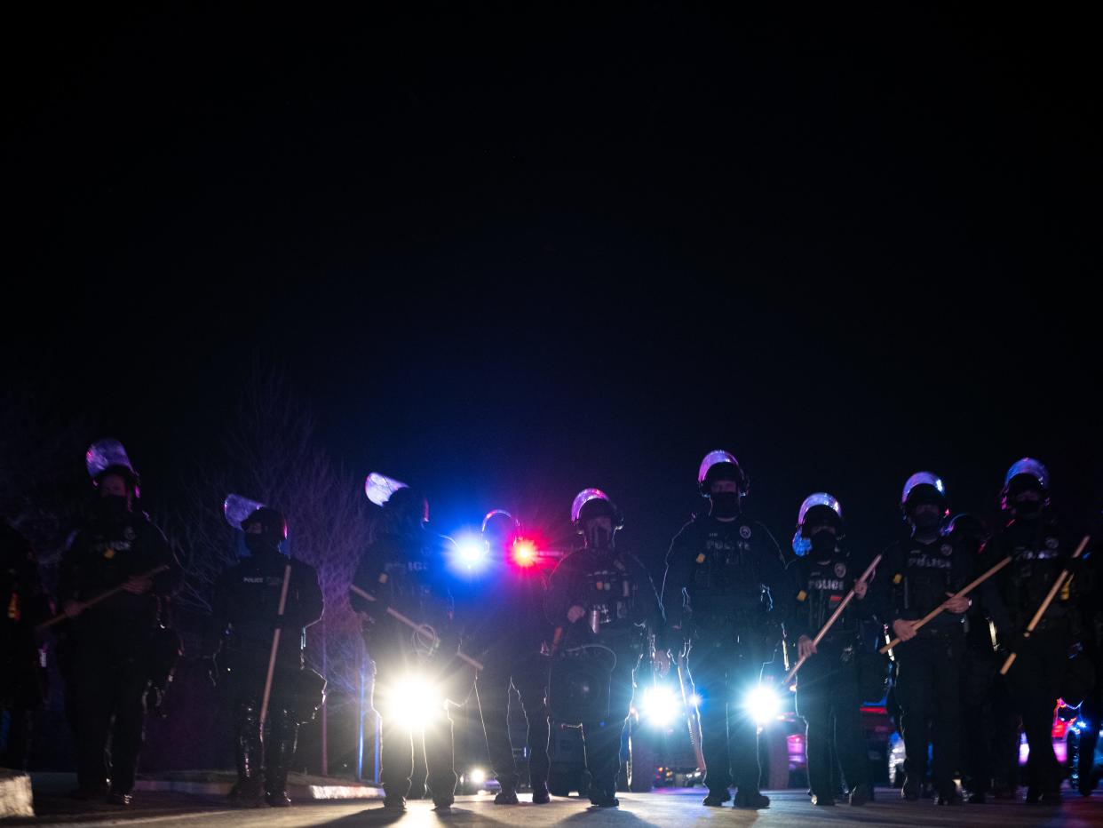 Louisville Metro Police Department officers march toward a group of protesters after the Breonna Taylor memorial events on March 13, 2021 in Louisville, Kentucky. Today marks the one year anniversary since Taylor was killed in her apartment during a botched no-knock raid executed by LMPD.