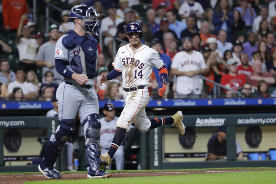 Houston Astros’ <a class="link " href="https://sports.yahoo.com/mlb/players/10524/" data-i13n="sec:content-canvas;subsec:anchor_text;elm:context_link" data-ylk="slk:Mauricio Dubon;sec:content-canvas;subsec:anchor_text;elm:context_link;itc:0">Mauricio Dubon</a> (14) scores behind Cleveland Guardians catcher <a class="link " href="https://sports.yahoo.com/mlb/players/61262/" data-i13n="sec:content-canvas;subsec:anchor_text;elm:context_link" data-ylk="slk:David Fry;sec:content-canvas;subsec:anchor_text;elm:context_link;itc:0">David Fry</a>, left, on the RBI single by <a class="link " href="https://sports.yahoo.com/mlb/players/8996/" data-i13n="sec:content-canvas;subsec:anchor_text;elm:context_link" data-ylk="slk:Jose Altuve;sec:content-canvas;subsec:anchor_text;elm:context_link;itc:0">Jose Altuve</a> during the sixth inning of a baseball game Wednesday, May 1, 2024, in Houston. (AP Photo/Michael Wyke)