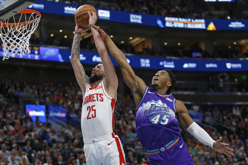 Utah Jazz guard Donovan Mitchell (45) fouls Houston Rockets guard Austin Rivers (25) as he goes to the basket in the first half during an NBA basketball game Monday, Jan. 27, 2020, in Salt Lake City. (AP Photo/Rick Bowmer)