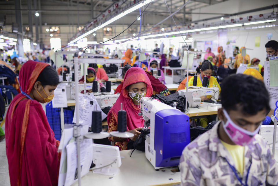 Garment factory employees work at Arrival Fashion Ltd. in Gazipur, Bangladesh, Saturday, March 13, 2021. On the eve of a half-century of independence this week, Bangladesh has been hailed as a success story for a young nation born out of strife and turbulence. Millions have risen out of poverty as the country has unexpectedly become one of Asia’s fastest-growing economies thanks to sectors like its garment industry, which clothes millions around the world. (AP Photo/Mahmud Hossain Opu)