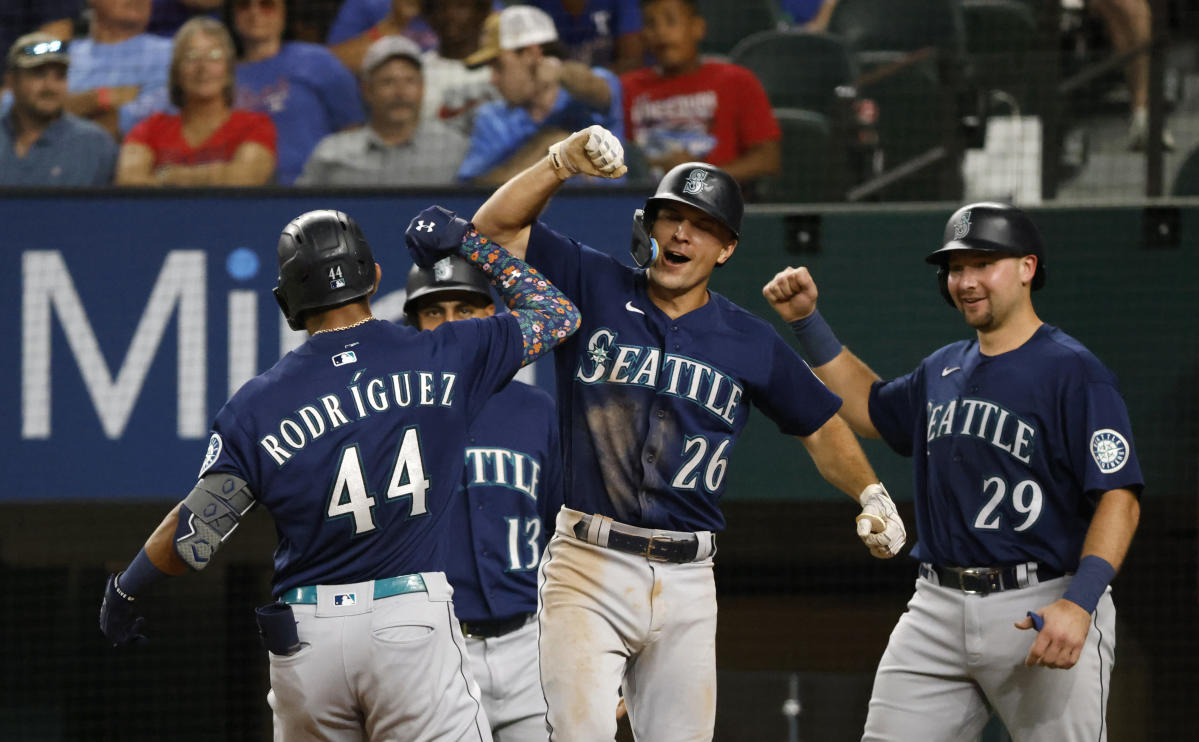 Seattle Mariners players, wearing special player's weekend jerseys with  nicknames in place of their last names, line the field during the national  anthem before a baseball game against the Toronto Blue Jays