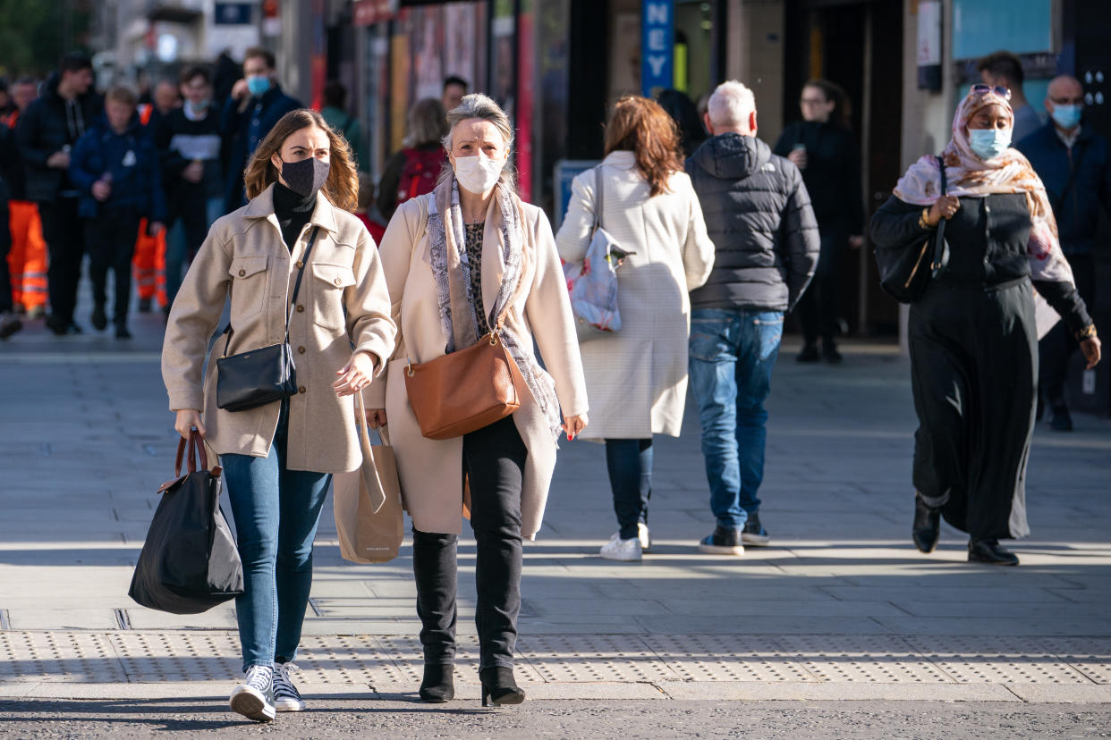 Shoppers wearing face masks on Oxford Street, in central London, as the Department of Health and Social Care is calling upon eligible people to get their covid-19 booster vaccinations. Picture date: Friday October 22, 2021. (Photo by Dominic Lipinski/PA Images via Getty Images)