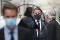 French President Emmanuel Macron wearing a protective face mask visits a factory of manufacturer Valeo in Etaples, , northern France, Tuesday May 26, 2020. Emmanuel Macron announced a 8 billion euro ($8.8 billion) plan Tuesday to save the country's car industry from huge losses wrought by virus lockdowns, including a big boost for electric vehicles. The plan includes government subsidies for car buyers and longer-term investment in innovative technology, especially in battery-powered cars. (Ludovic Marin, Pool via AP)