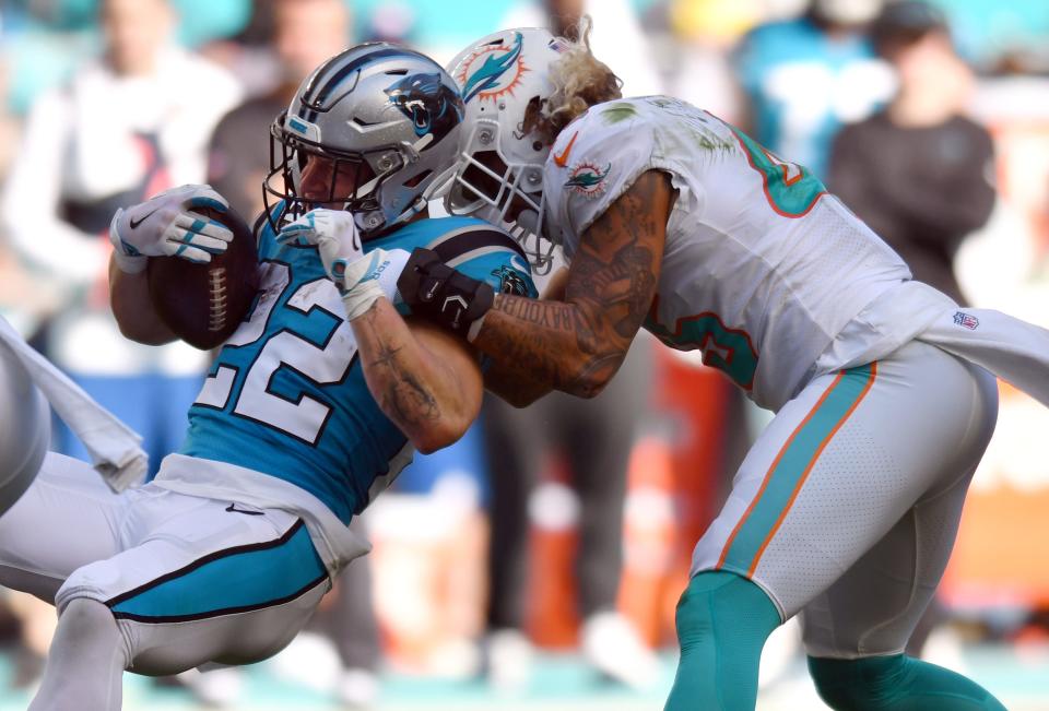 Dolphins linebacker Duke Riley tackles Panthers running back Christian McCaffrey during the first quarter of Sunday's game at Hard Rock Stadium. McCaffrey later would leave with an injured ankle and is out for the rest of the season.