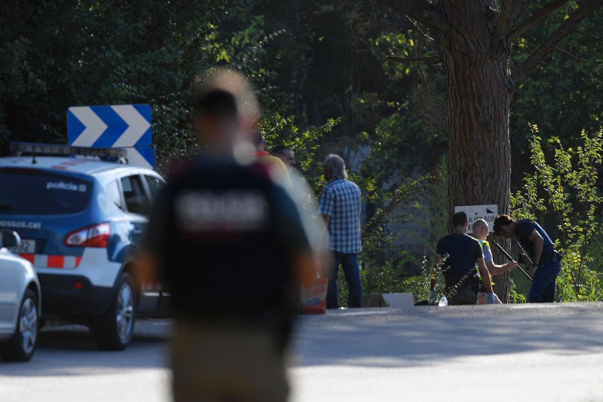 Spanish policemen check the site where Younes Abouyaaqoub was shot: Getty