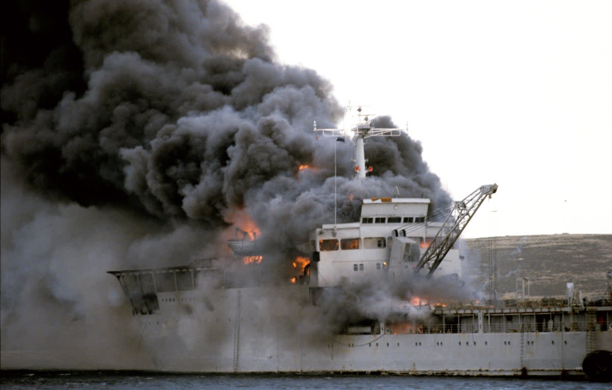 Landing Ship Logistic RFA Sir Galahad ablaze after the Argentine air raid on June 8th at Bluff Cove near Fitzroy settlement on East Falkland (PA)