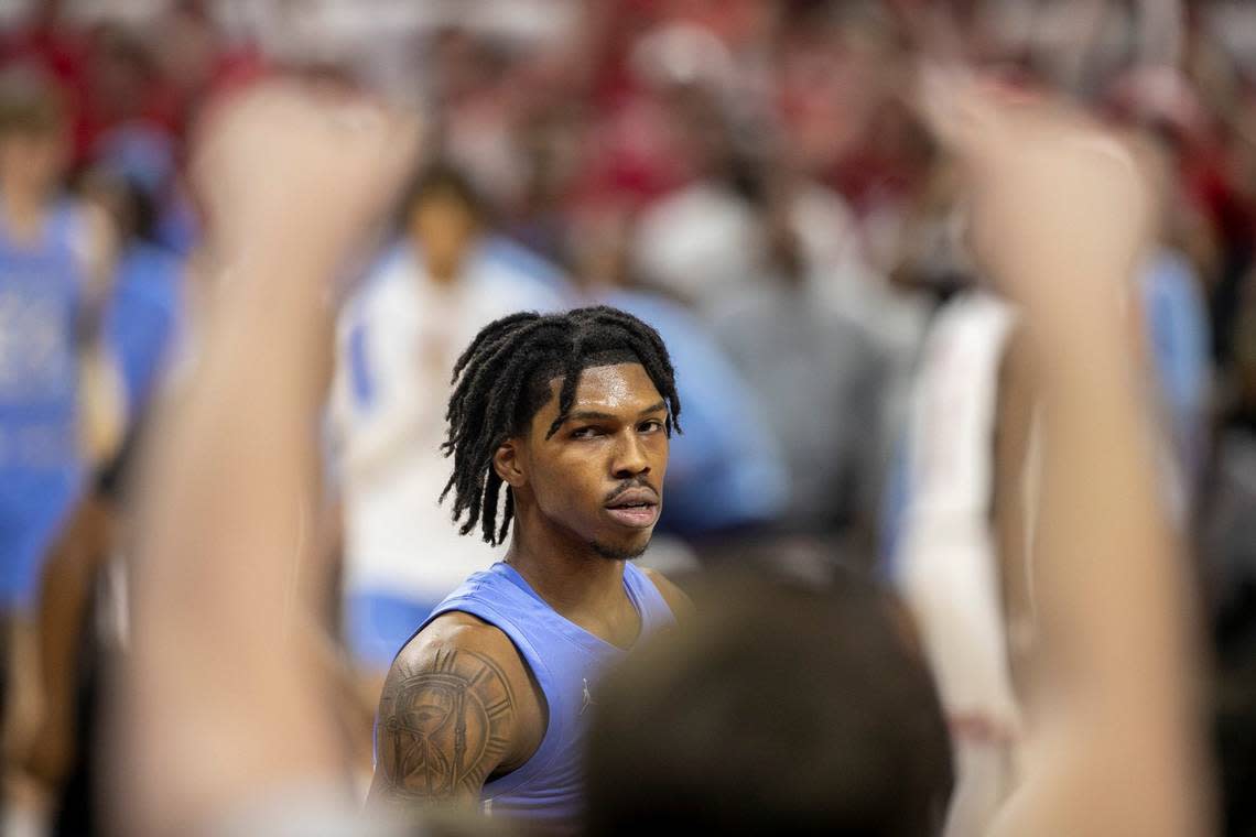 North Carolina’s Caleb Love (2) eyes the N.C. State student section as they heckle him after a foul in the second half on Sunday, February 19, 2023 at PNC Arena in Raleigh, N.C.