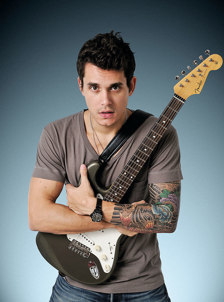 Mayer posing for a portrait in 2008 and hugging his guitar