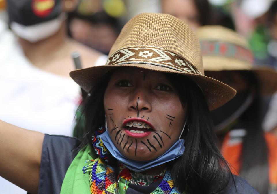 An Indigenous woman marches during a national strike in Bogota, Colombia, Wednesday, Oct. 21, 2020. Workers' unions, university students, human rights defenders, and Indigenous communities held a day of protest in conjunction with a national strike across Colombia to protest against the assassinations of social leaders, in defense of the right to protest and to demand advances in health, income and employment. (AP Photo/Fernando Vergara)