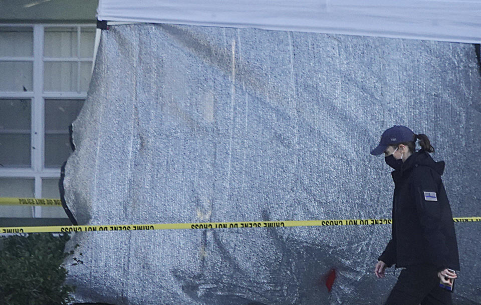 Law enforcement personnel continue to work at an apartment complex the day after a deadly shooting in Sunrise, Wednesday, Feb. 3, 2021. Several FBI agents were killed and others were wounded while trying to serve a search warrant on a child pornography suspect in Florida. FBI authorities say the suspect also died. (Joe Cavaretta/South Florida Sun-Sentinel via AP)