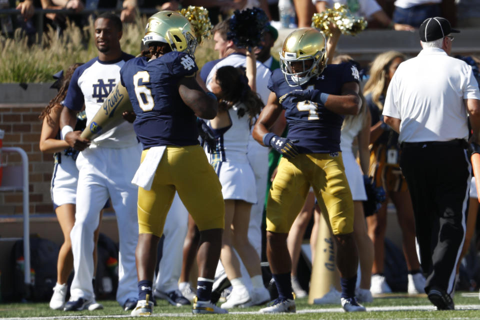 Notre Dame's Avery Davis (4) celebrates his 59-yard touchdown reception with Tony Jones Jr. (6) in the first half of an NCAA college football game against New Mexico in South Bend, Ind., Saturday, Sept. 14, 2019. (AP Photo/Paul Sancya)