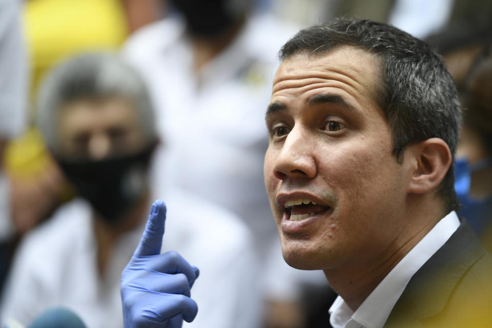 Venezuelan opposition leader Juan Guaido speaks upon his arrival to the headquarters of Democratic Action political party in Caracas, Venezuela, Wednesday, June 17, 2020, the day after Venezuela's Supreme Court ordered its takeover ahead of parliamentary elections expected this year. (AP Photo/Matias Delacroix)