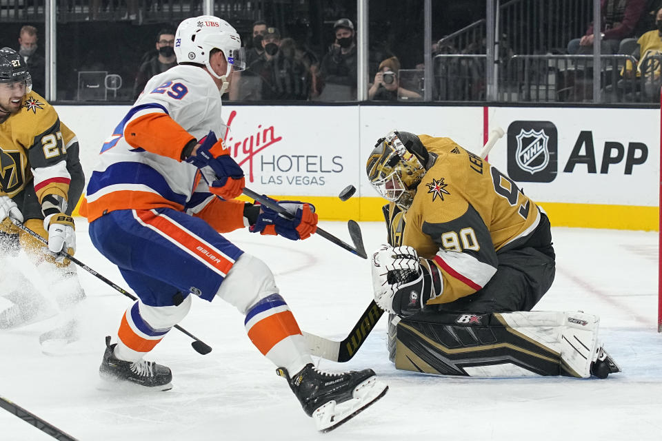 Vegas Golden Knights goalie Robin Lehner (90) makes a save against New York Islanders center Brock Nelson (29) in the first period during an NHL hockey game, Sunday, Oct. 24, 2021, in Las Vegas. (AP Photo/Rick Scuteri)