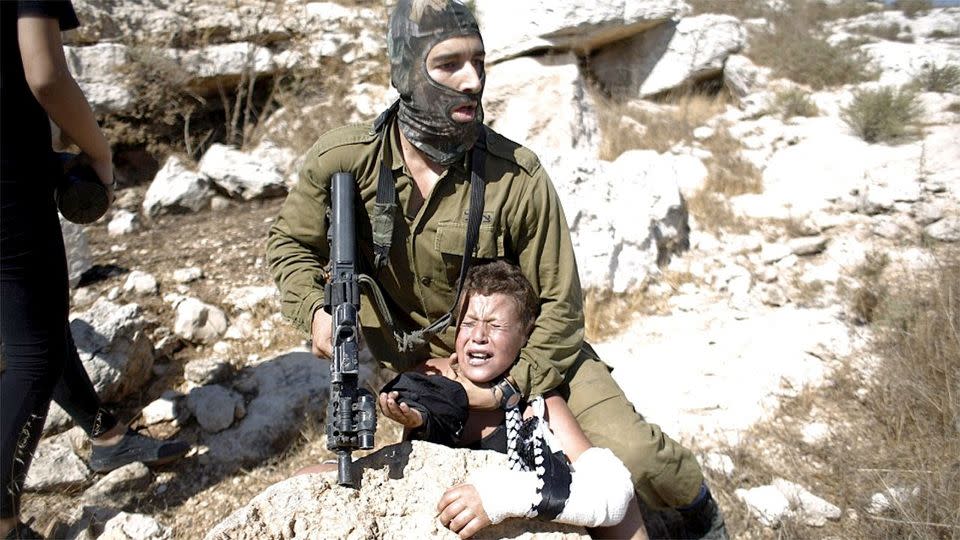 The Israeli soldier was said to have put the young boy in a headlock at gunpoint in West Bank, after concerns for their safety were raised. Photo: Reuters.