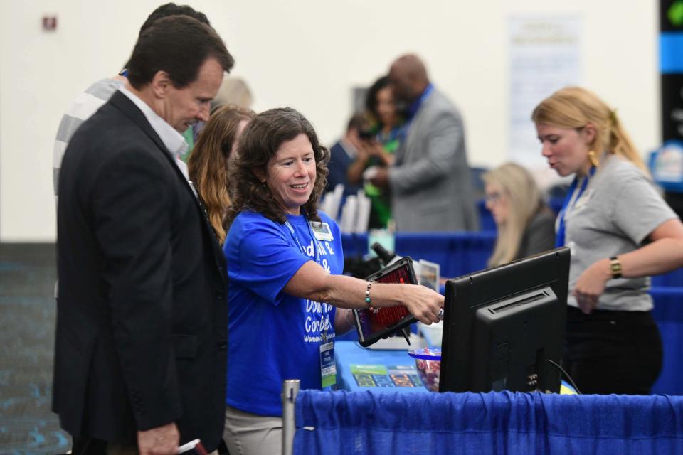 Diane Fraser, director of the Emerald Coast Science Center, gives a demonstration of the center's planetarium to David Lambert on Tuesday during the fifth annual TeCMEN Industry Day held at the Destin-Fort Walton Beach Convention Center on Okaloosa Island.