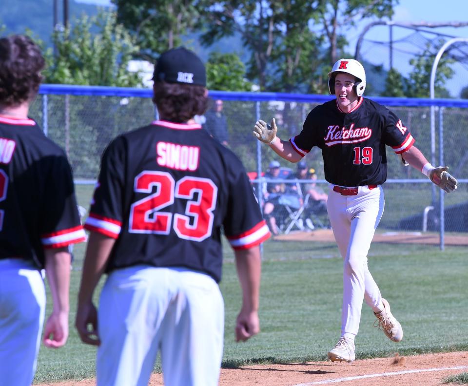 Roy C. Ketcham's Riley Weatherwax is greeted by teammates after hitting a three-run homer in an 11-0 win over Corning in a NYSPHSAA Class AAA baseball subregional May 30, 2024 at Horseheads High School.