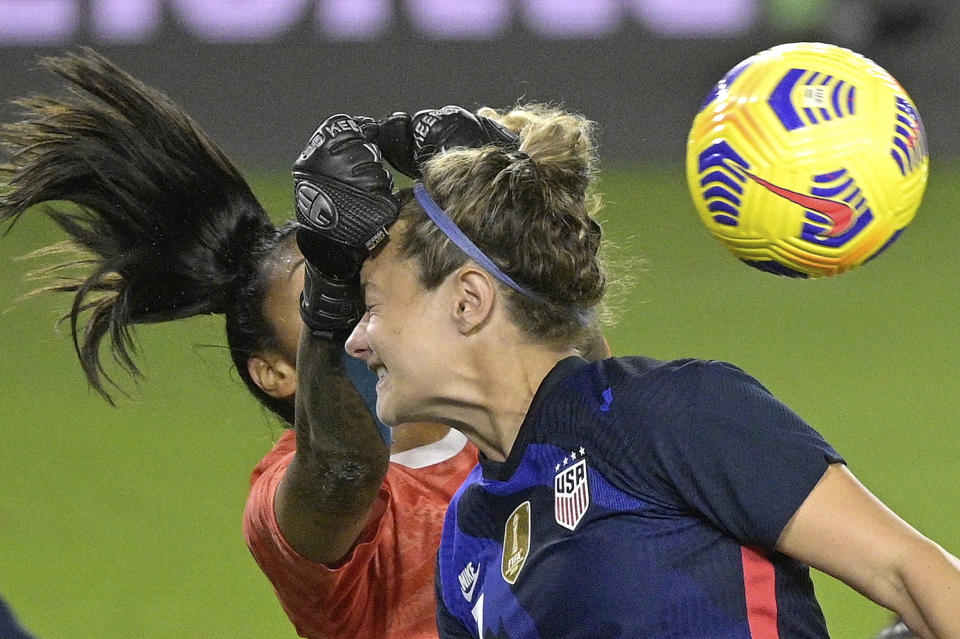 Argentina goalkeeper Solana Pereyra, left, knocks the ball away as United States midfielder Jaelin Howell attempts a header on goal off a corner kick during the second half of a SheBelieves Cup women's soccer match, Wednesday, Feb. 24, 2021, in Orlando, Fla. (AP Photo/Phelan M. Ebenhack)