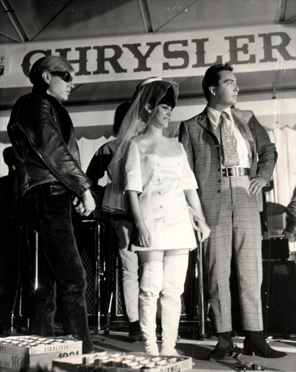 Andy Warhol, left, stands with bride Randy McNair and groom Gary Norris at Warhol’s Mod Wedding, a pop-art extravaganza that was part of the Carnaby Street Fun Festival at the State Fairgrounds Coliseum in Detroit in November 1966.