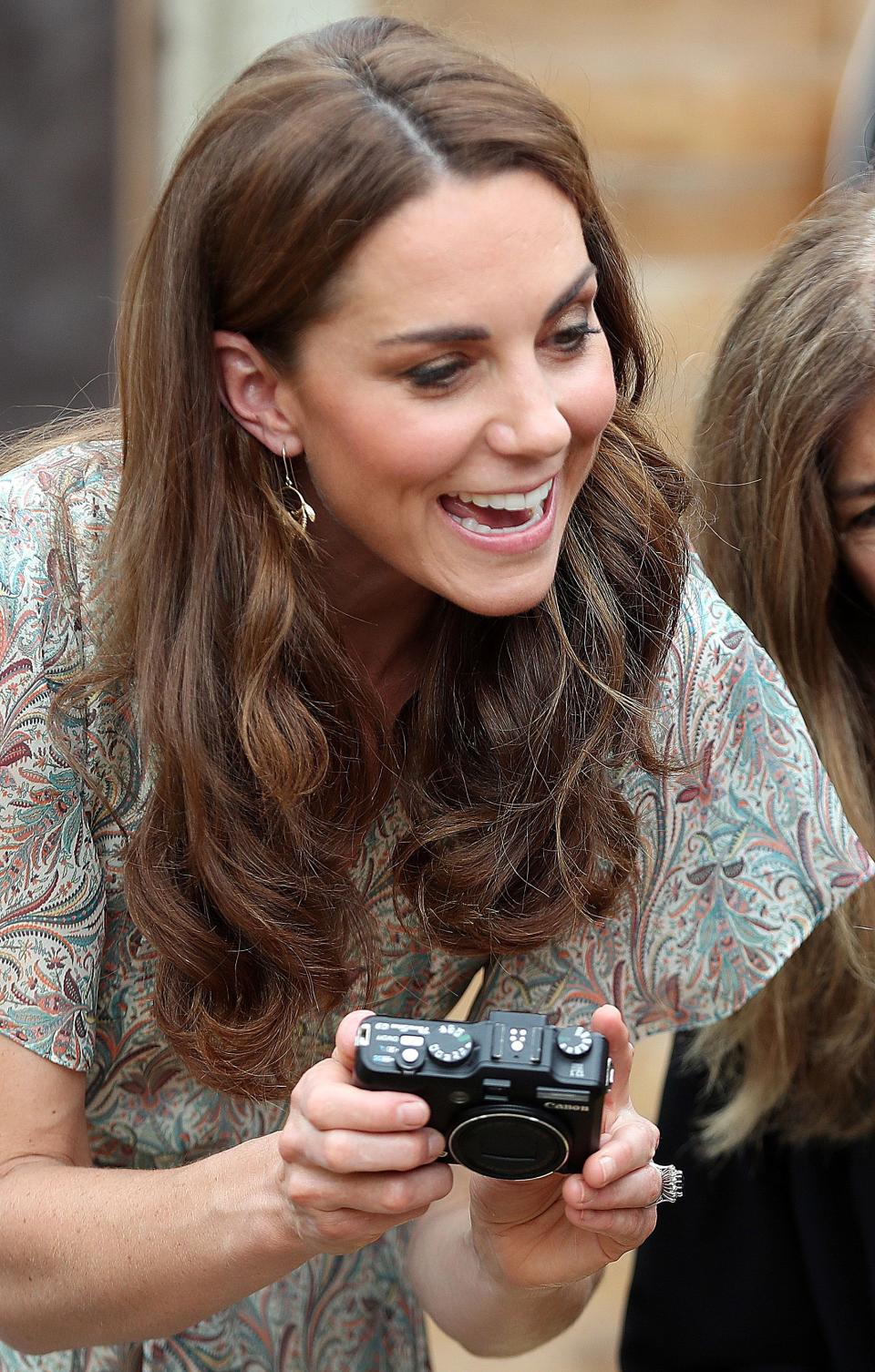 Britain's Catherine, Duchess of Cambridge holds a camera as she takes part in a a photography workshop with the charity 'Action for Children' in Kingston, southwest London on June 25, 2019. (Photo by Chris Jackson / POOL / AFP)        (Photo credit should read CHRIS JACKSON/AFP via Getty Images)