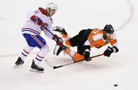 Philadelphia Flyers centre Claude Giroux (28) falls to the ice as he battles Montreal Canadiens centre Jesperi Kotkaniemi (15) for the puck during first period of NHL Eastern Conference Stanley Cup first round playoff action in Toronto on Friday, Aug. 14, 2020. (Frank Gunn/The Canadian Press via AP)