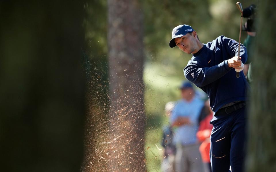 Nicolai Hojgaard, of Denmark, hits from the pine straw on the first hole during second round