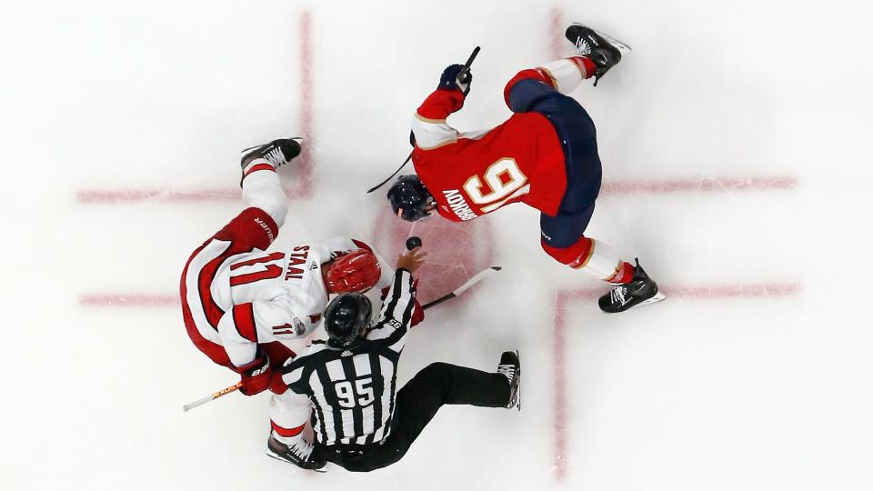 SUNRISE, FL - MAY 24: Linesman Jonny Murray #95 drops the puck between Jordan Staal #11 of the Carolina Hurricanes and Aleksander Barkov #16 of the Florida Panthers in Game Four of the Eastern Conference Final of the 2023 Stanley Cup Playoffs at the FLA Live Arena on May 24, 2023 in Sunrise, Florida. (Photo by Joel Auerbach/Getty Images)