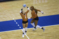 Texas' Jhenna Gabriel (2) sets the ball for Asjia O'Neal (7) against during the first set against Wisconsin in a semifinal in the NCAA women's volleyball championships Thursday, April 22, 2021, in Omaha, Neb. (AP Photo/John Peterson)