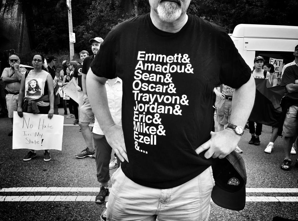 <p>A man wears a shirt depicting African-Americans killed by police or other violence during a counterprotest against a “free speech” rally staged by conservative activists Aug. 19 in Boston. (Photo: Holly Bailey/Yahoo News) </p>