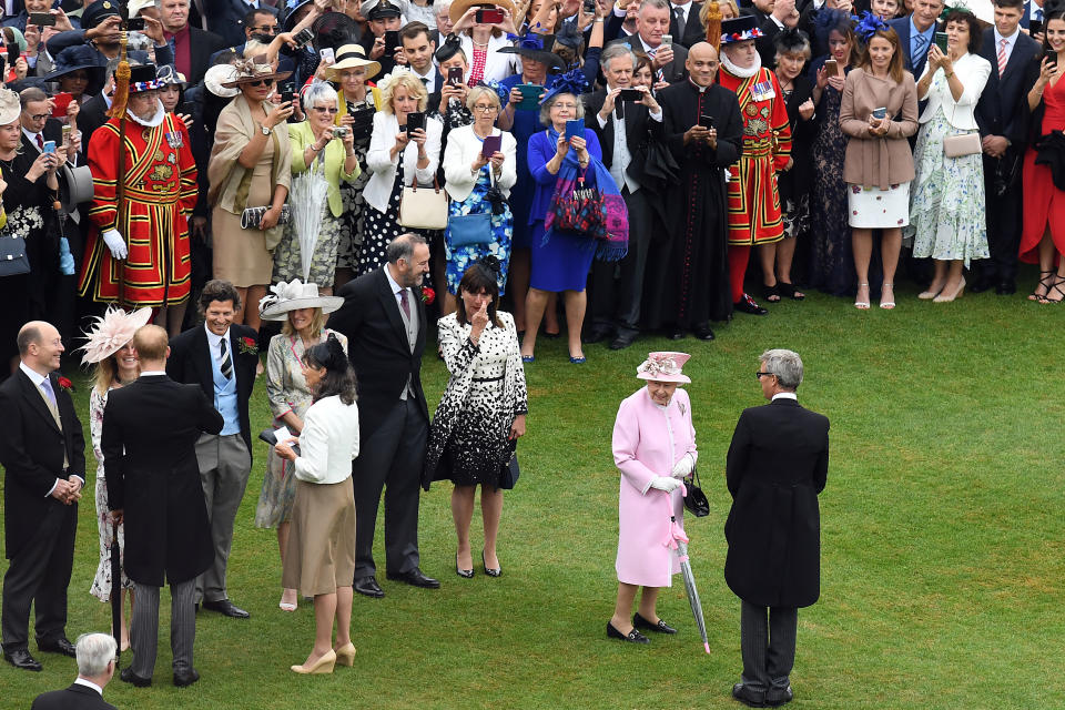 Britain's Queen Elizabeth II and Britain's Prince Harry, Duke of Sussex greet guests at the Queen's Garden Party in Buckingham Palace, central London on May 29, 2019. (Photo by Stuart C. Wilson / POOL / AFP)        (Photo credit should read STUART C. WILSON/AFP via Getty Images)